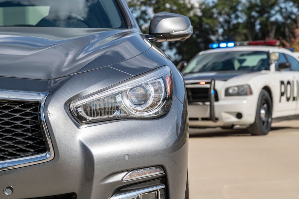 Police Car Stopped A Grey Car