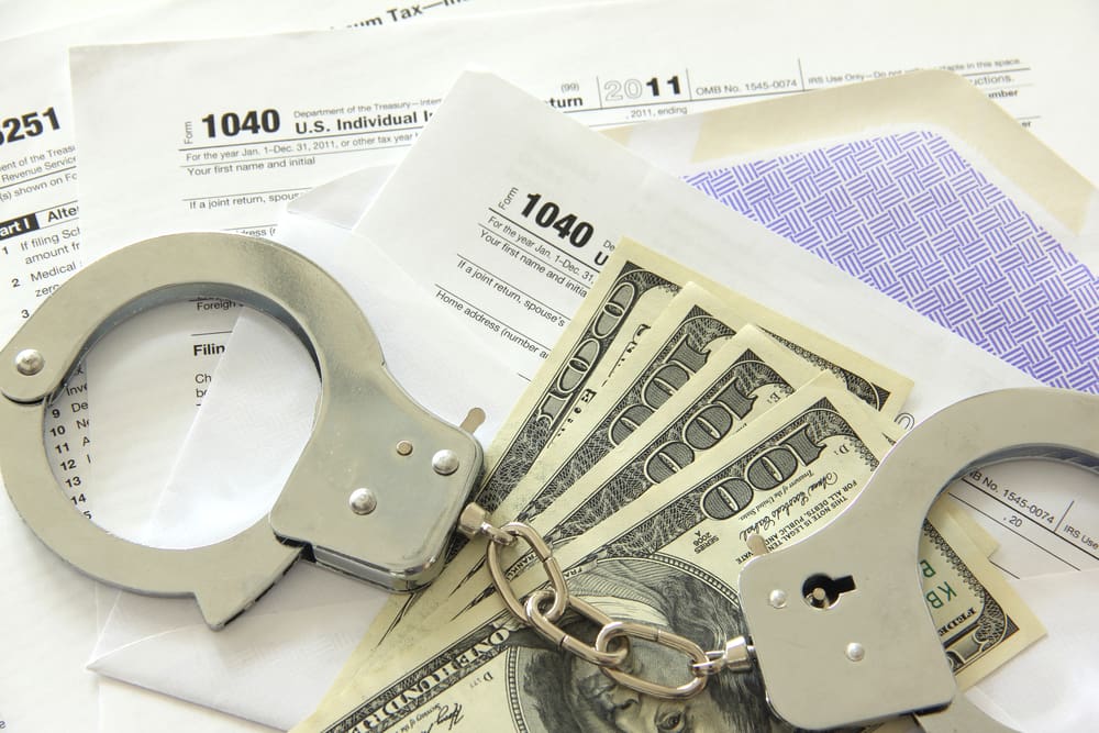 Fines, Cash And Handcuffs On The Table