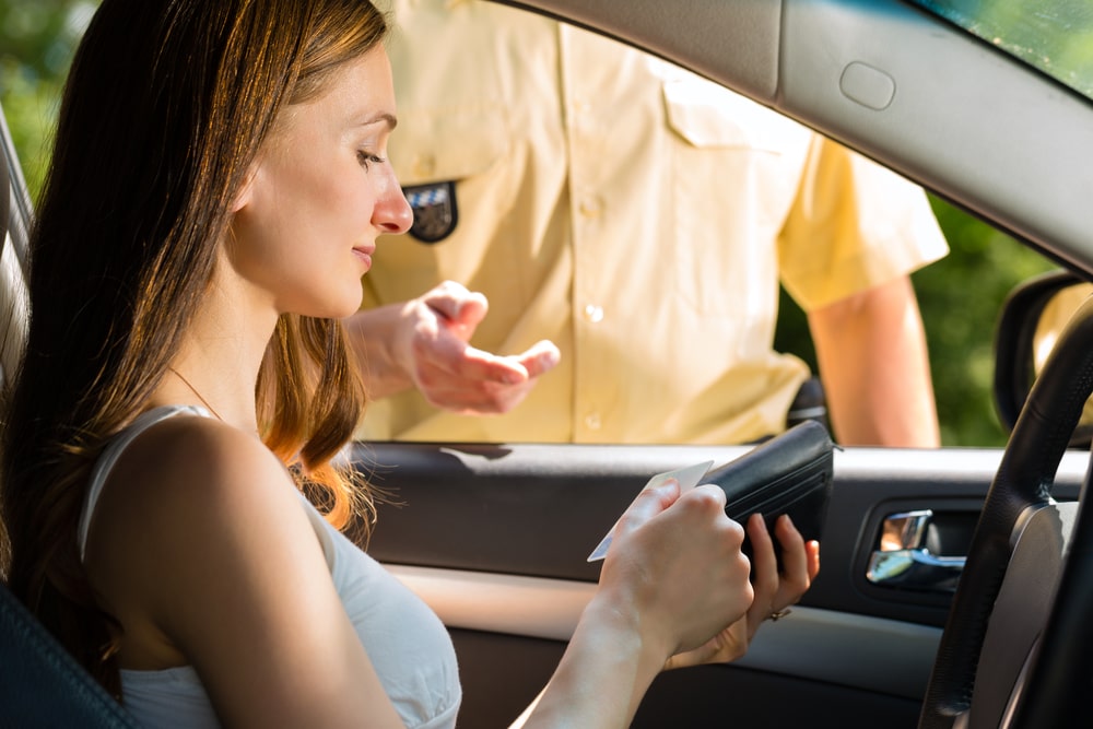 Woman Driver Handing Her License Over To A Police Man