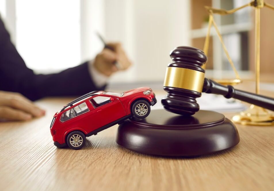 Toy car on gavel with scales.