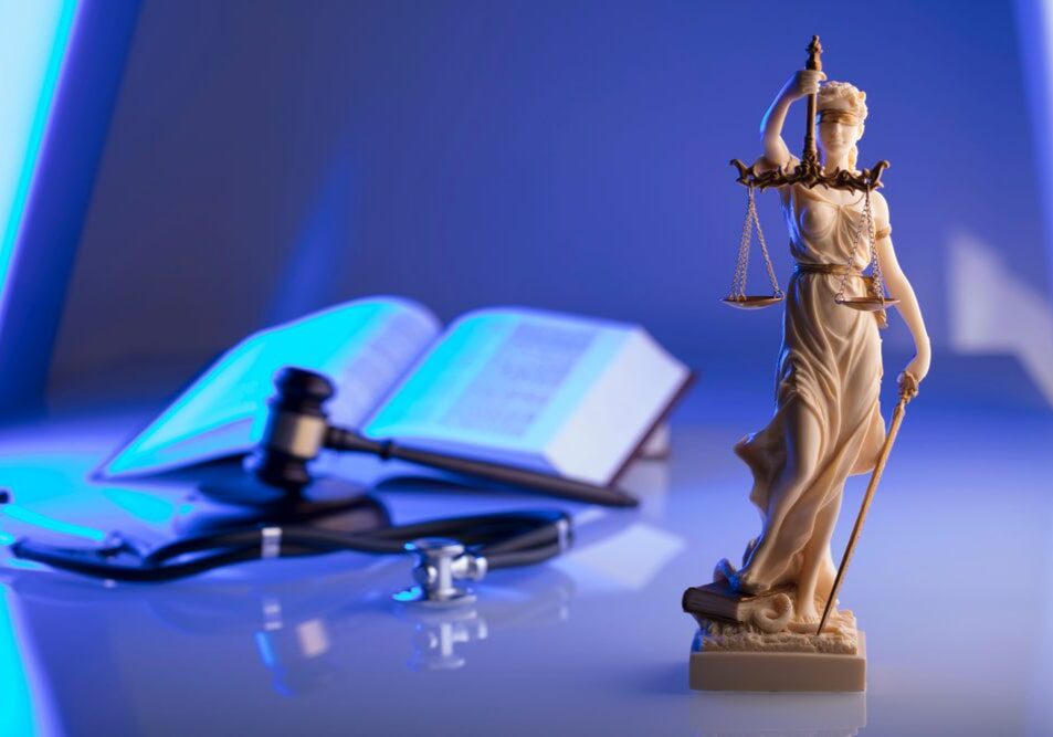 Lady Justice statue with gavel and book.